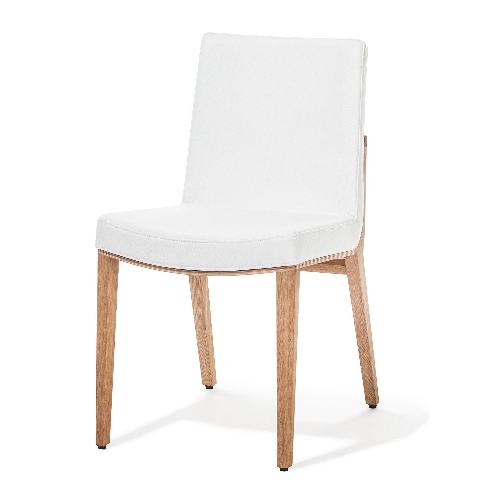 Experience the Moritz chair from TON, a modern white piece with a cushioned seat and backrest. It features light oak wooden legs angled slightly outward, reflecting minimalist design and refined simplicity.