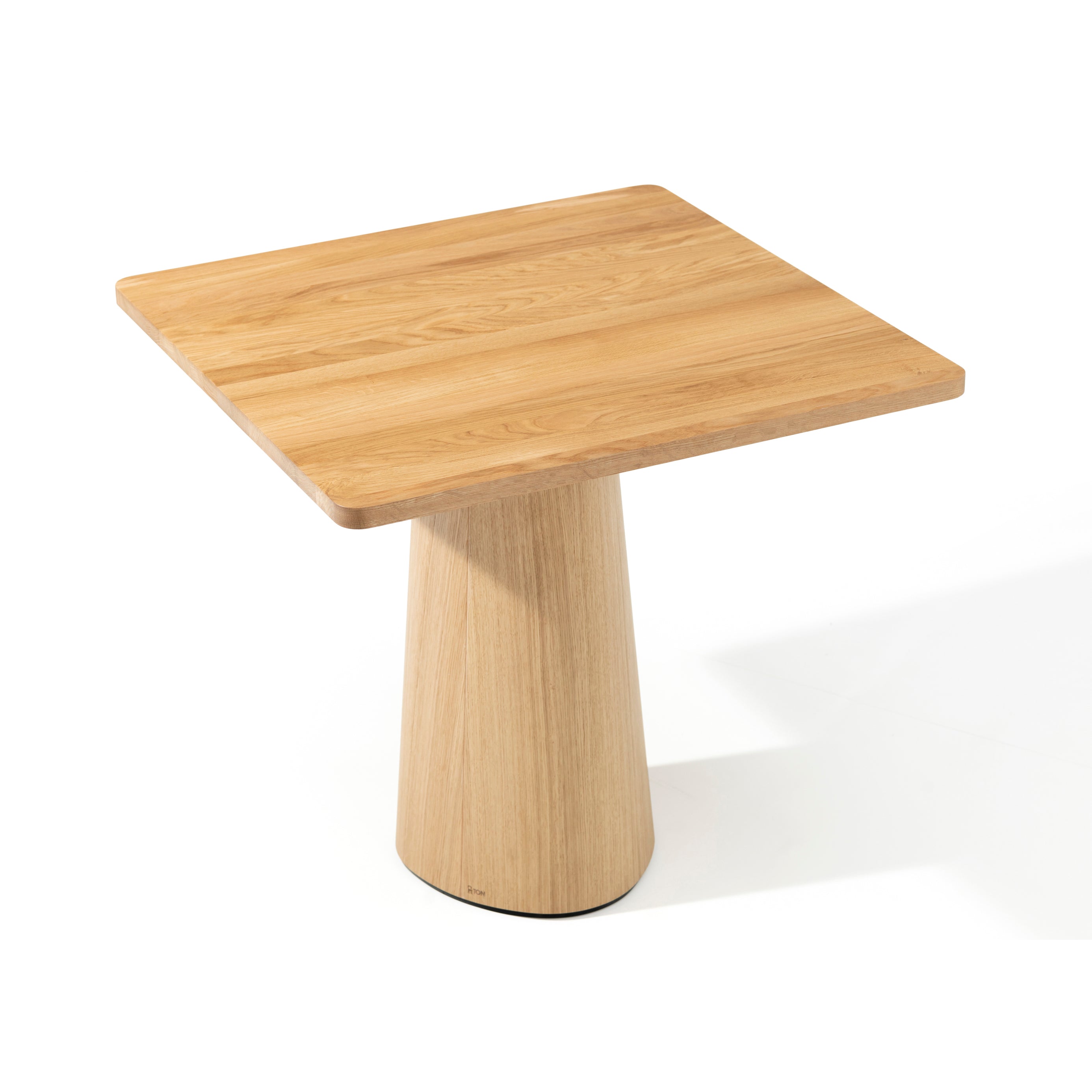 The P.O.V. Table 460 by TON is a minimalist square wooden table with a smooth, light brown finish. Its broad top and organically shaped conical base highlight its modern design, while the white background emphasizes the natural wood texture and elegant craftsmanship.