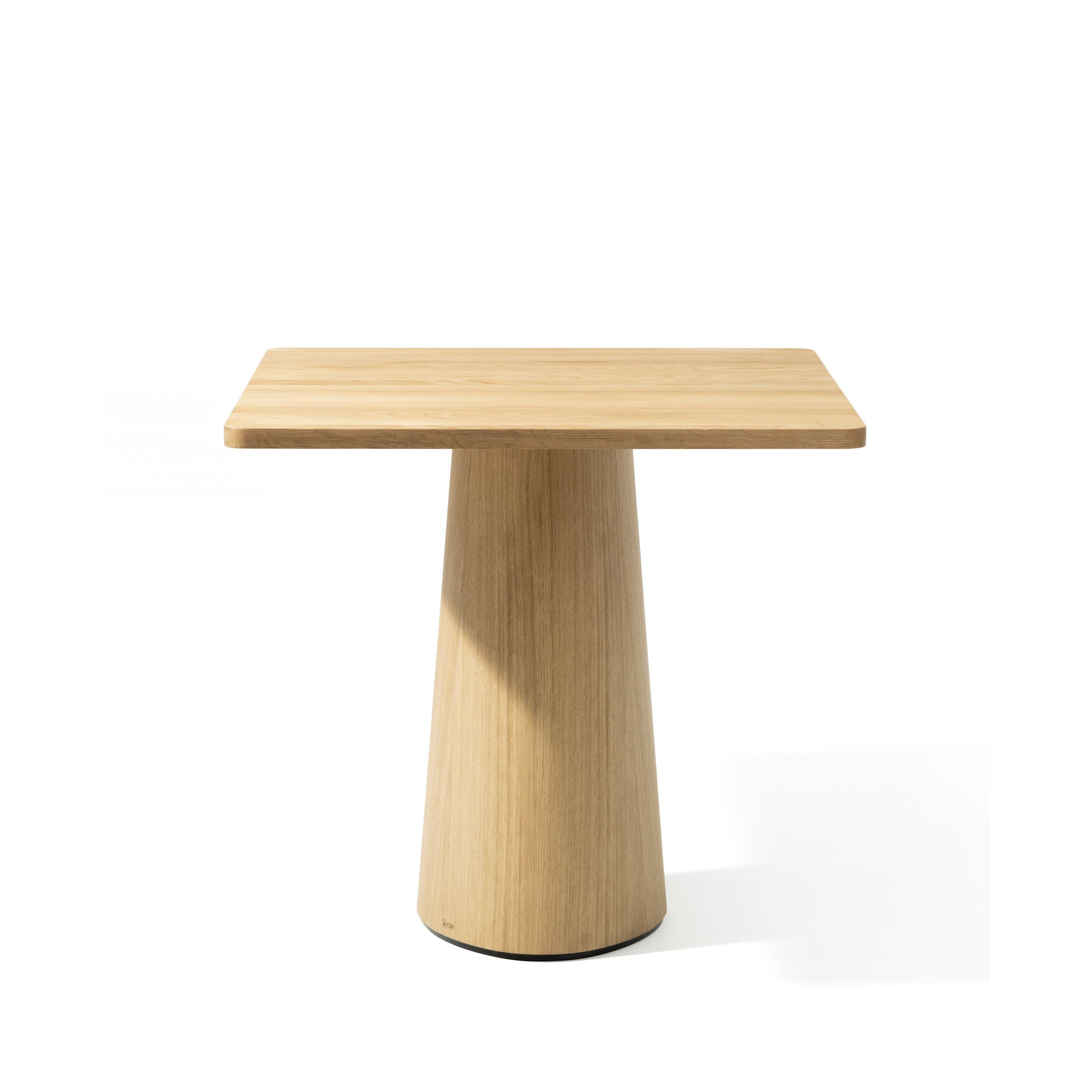 The P.O.V. Table 460 by TON is a square wooden table with a light wood finish, featuring a flat tabletop made from premium materials and an organically shaped base, set against a plain white background.