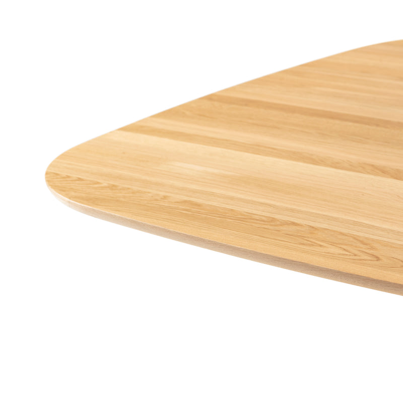 Close-up of the P.O.V. Table 462 by TON, featuring a smooth, polished wooden tabletop with rounded edges. Its natural grain pattern is well-crafted, complementing an organically shaped base.