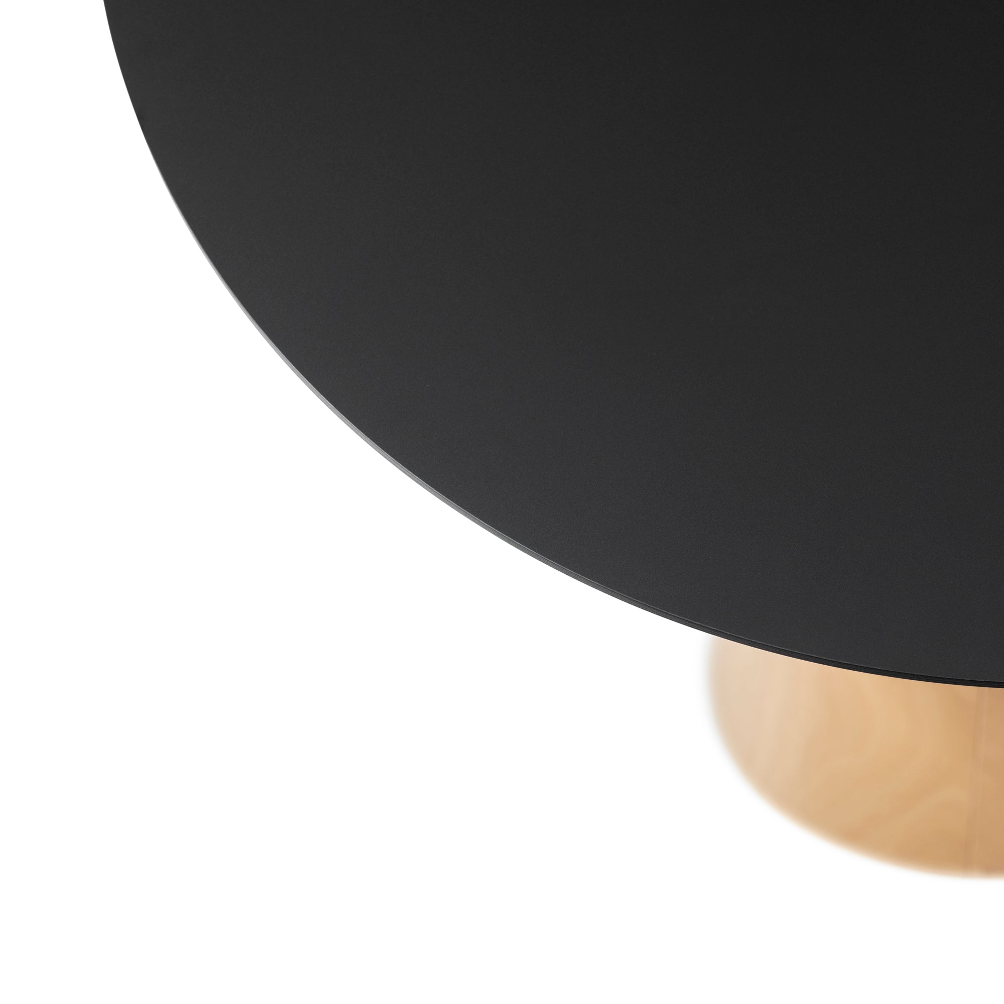 A close-up shot of the P.O.V. Table 463 by TON features its organically shaped black top and light wooden base. The lower left corner shows a white background, highlighting the contrast between the tables design and surroundings.