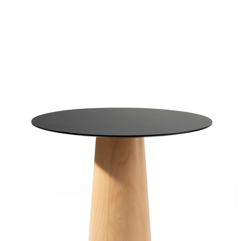 The P.O.V. Table 463 by TON is a minimalist piece featuring an organically shaped black top and wooden conical base, displayed against a white background.