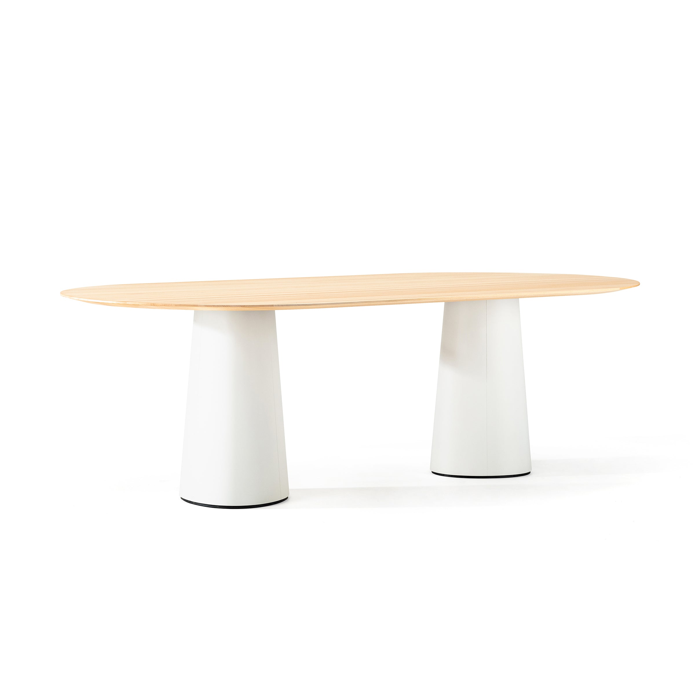 The P.O.V. Table 464 by TON showcases a minimalist design with a light wood oval top and two wide cylindrical legs on an organically shaped base, set against a plain white background for a fresh take on modern decor.