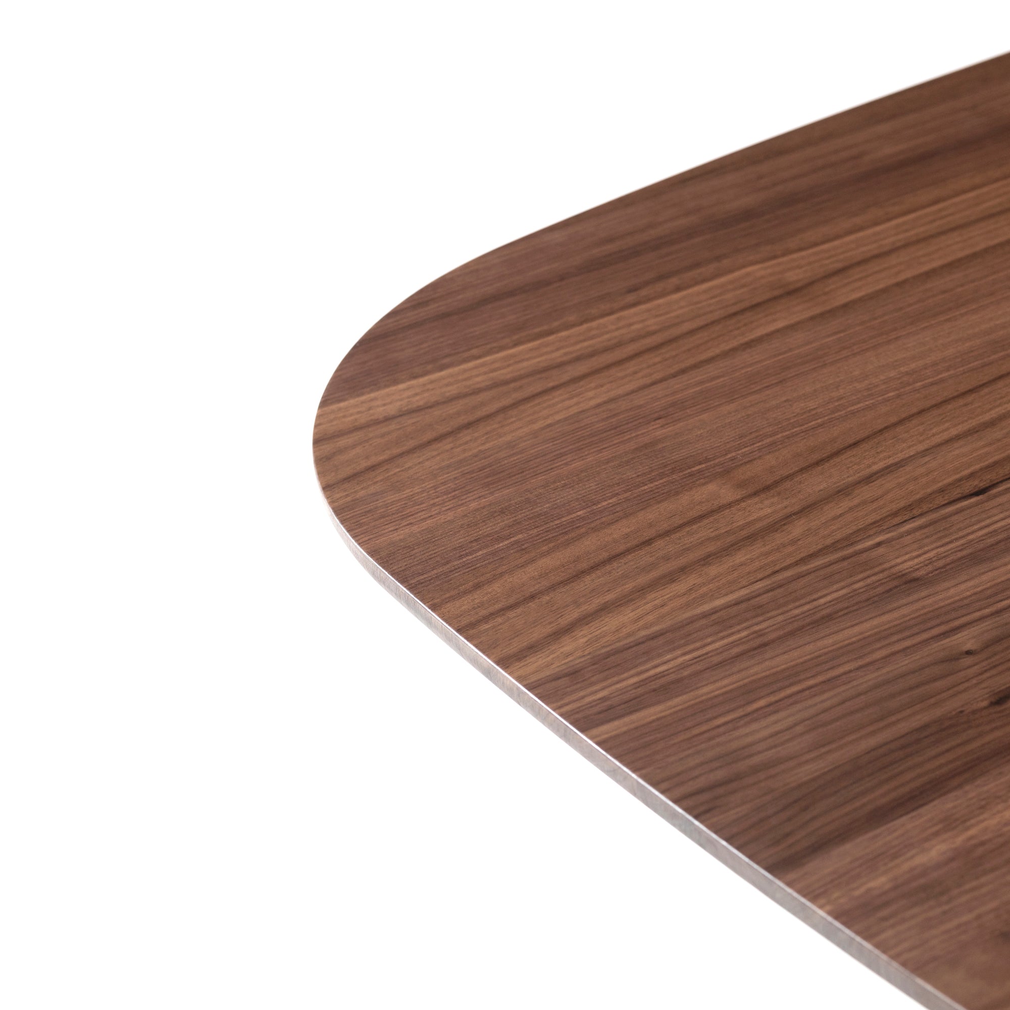 Close-up of the corner of a P.O.V. Table 466 by TON, made from solid wood with a rounded edge. The polished surface showcases beautiful wood grain patterns in shades of brown, highlighting its exquisite modular design.