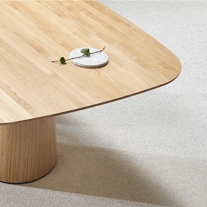 The TON P.O.V. Table 466, crafted from solid wood with smooth, rounded corners and a cylindrical base, stands on a carpeted floor. Its surface is adorned with a small, round marble coaster featuring a green leaf design.