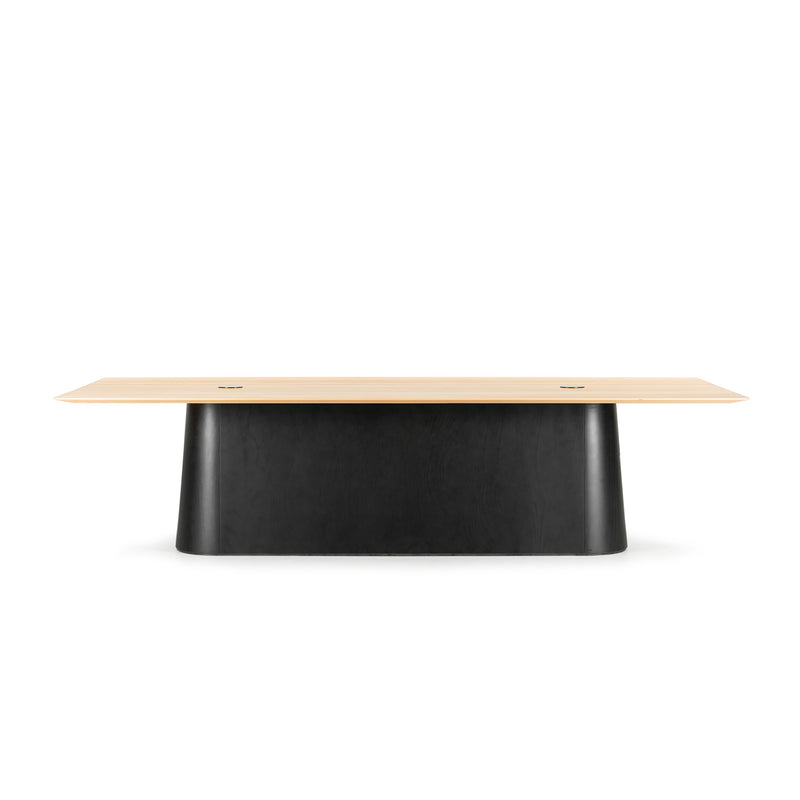 The P.O.V. Table 467 by TON is a modern rectangular conference table with a minimalist modular design, featuring a light solid wood top and sleek black base, ideal for office or meeting room settings.