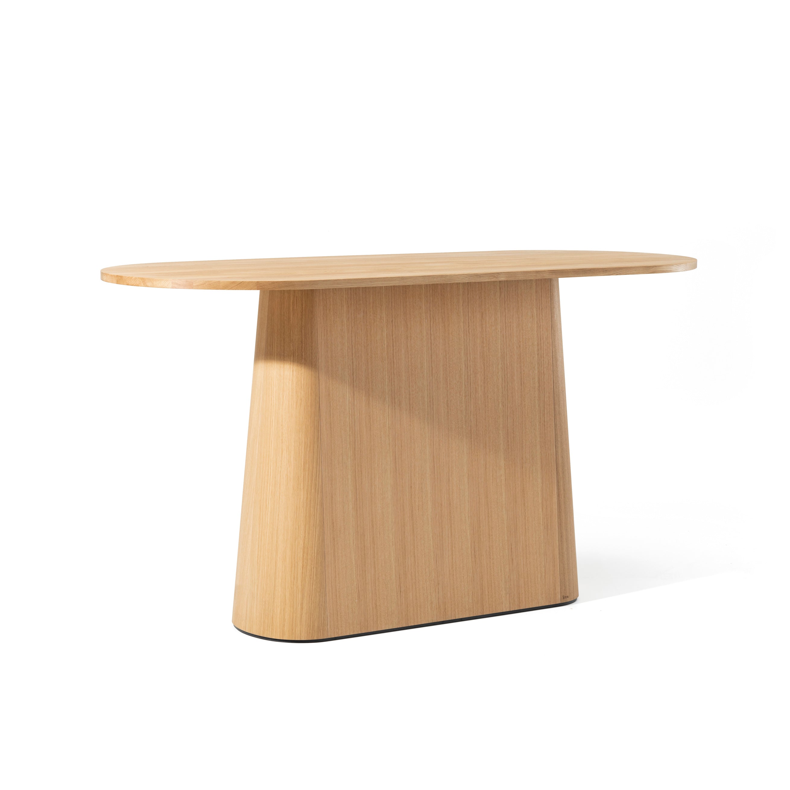 The P.O.V. Table 468 by TON is a modern, minimalist piece featuring a smooth oval top and an organically shaped trapezoidal base. Its light wood finish highlights a subtle grain pattern, set against a plain white background.