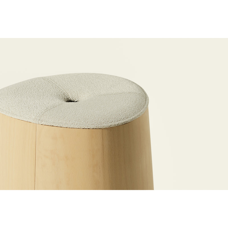 This close-up shows the P.O.V. Stool Upholstered by TON, a minimalist piece with clean lines crafted from American walnut. It features a light beige, textured, cushioned top against a simple background, highlighting its modern design.