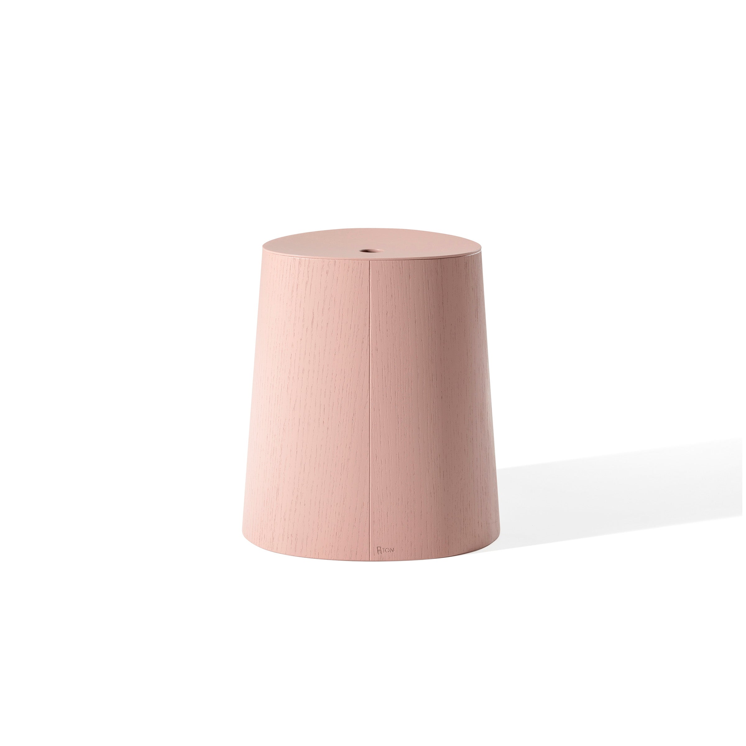The P.O.V. Stool by TON is a minimalist, cylindrical pink stool with a slightly tapered design and smooth surface. It appears against a plain white background, casting a subtle shadow to the right.