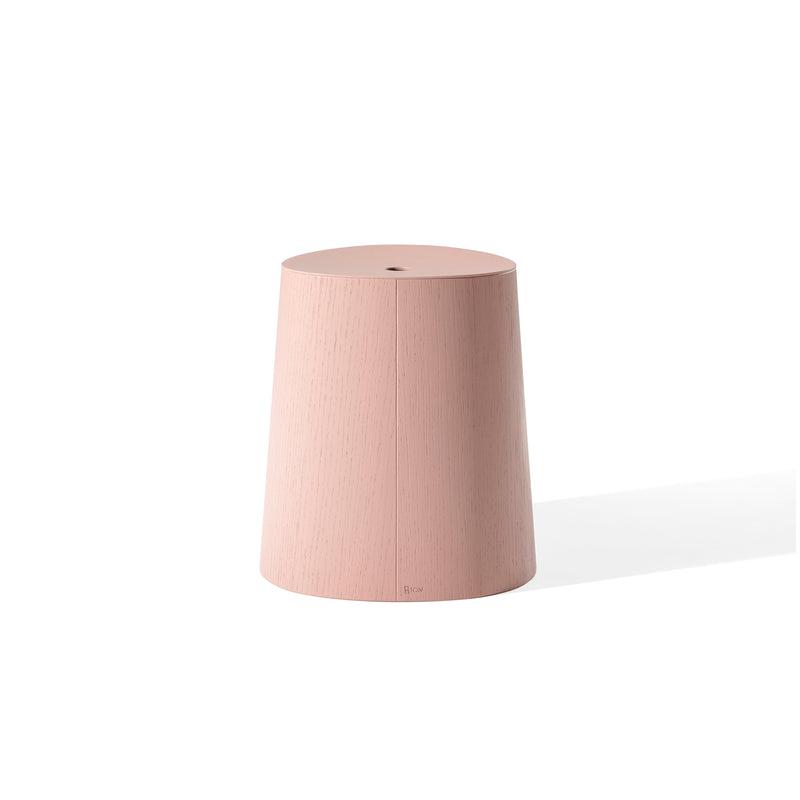 The P.O.V. Stool by TON is a minimalist, cylindrical pink stool with a slightly tapered design and smooth surface. It appears against a plain white background, casting a subtle shadow to the right.