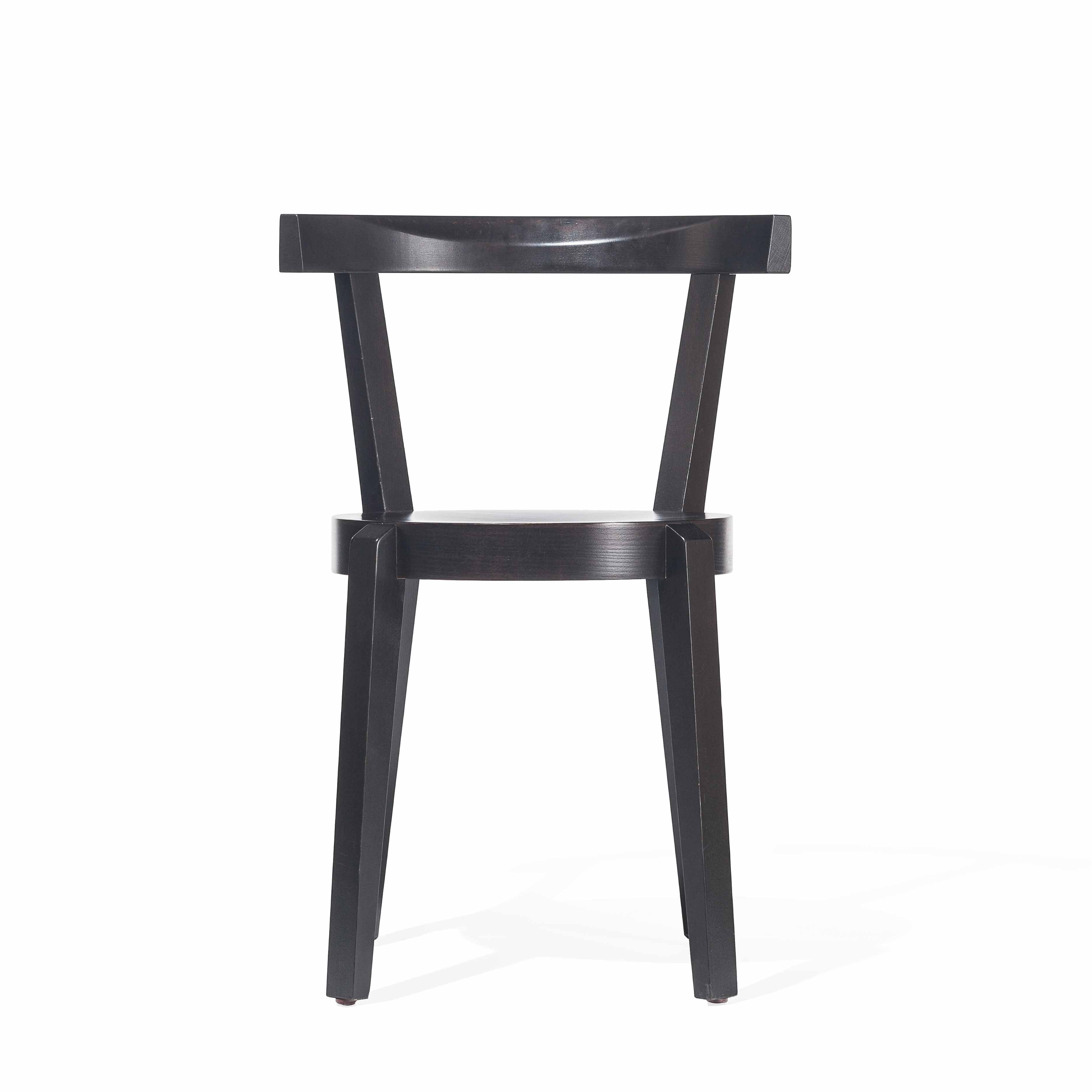 The modern Chair Punton by TON showcases a sleek black design with a straight backrest, gently angled legs, and a flat seat, artfully set against a plain white background.