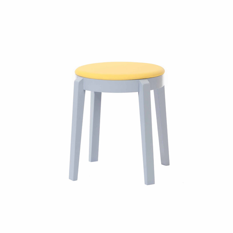 The Punton Upholstered Stool by TON features a simple round yellow cushioned seat with four light blue beech legs, embodying a minimalistic and modern design reminiscent of the TONDesigner style, showcased against a plain white background.
