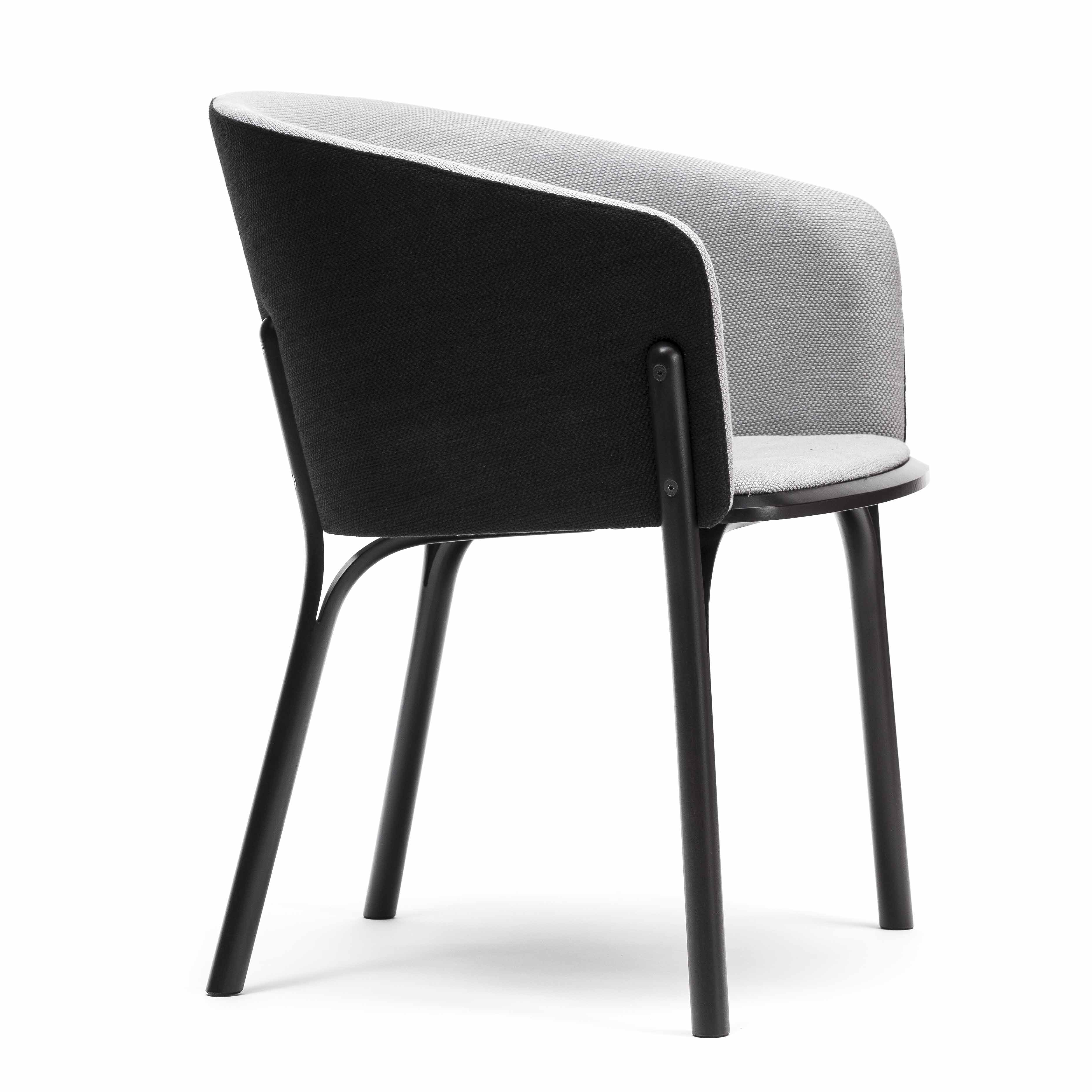 The Armchair Split by TON features a curved backrest with light gray fabric upholstery inside and black outside, supported by a sleek black metal frame. With its minimalist four-leg design, it combines comfort and contemporary appeal in a TONDesigner style.