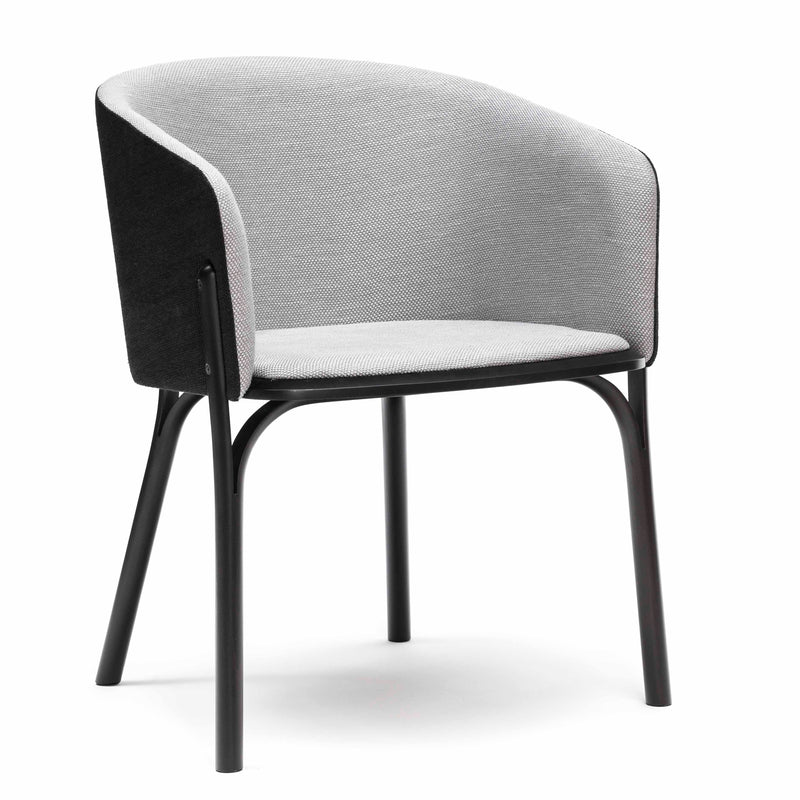 The Armchair Split by TON is a modern, minimalist chair featuring comfortable upholstery with a light gray seat and backrest on a black frame. Designed by TONDesigner, it boasts four sleek legs for a clean and contemporary look.