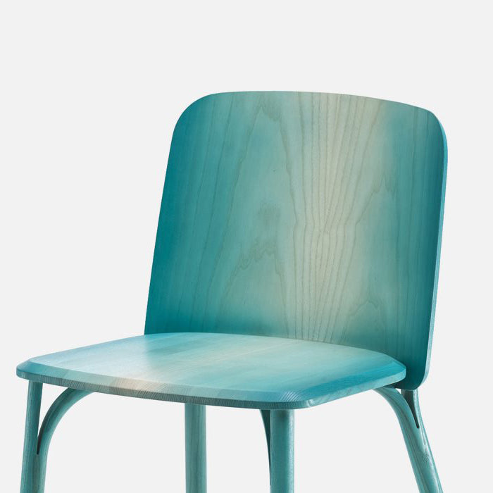 The Chair Split - Upholstered by TON offers a modern minimalist design with a smooth, light sea-green wooden seat and backrest. It features manually bent wood, clean lines, and a simple aesthetic against a plain white background.