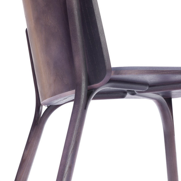 Close-up of the Chair Split - Upholstered by TON, featuring an elegantly designed dark wooden finish with sleek lines. The image showcases its backrest, seat, and manually bent wood legs, highlighting contemporary craftsmanship.