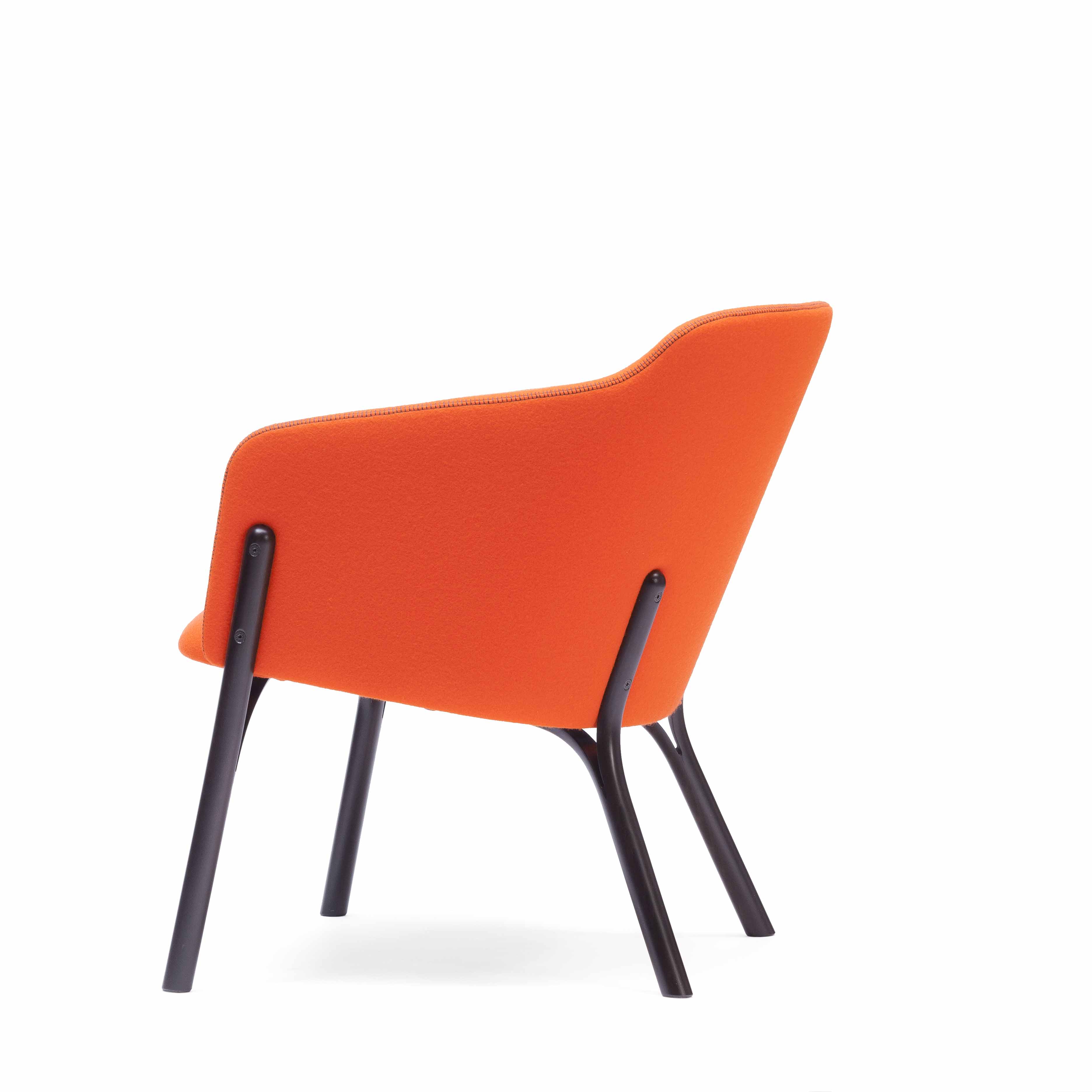 The Lounge Chair Split by TON features an orange modern design with a curved, elevated backrest and dark angled legs. This minimalist and contemporary chair showcases exquisite manual wood bending, viewed from the rear right side against a plain white background.