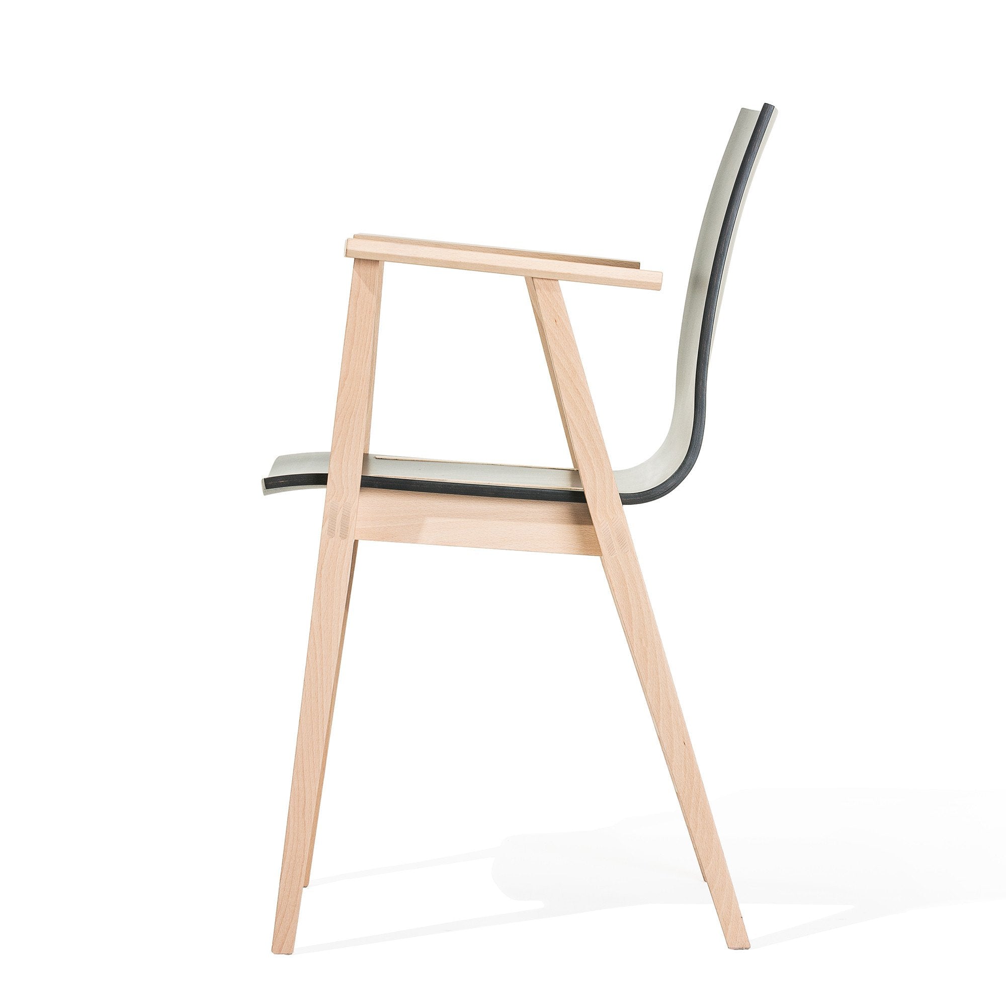 The Armchair Stockholm by TON showcases a sleek Scandinavian design with a light beech wood frame, thin armrests, and a slightly curved bent plywood backrest, offering an elegant and balanced silhouette.