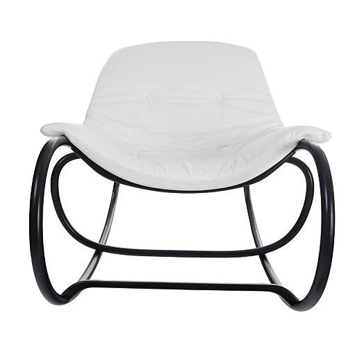 The Wave rocking armchair by TON is a sleek, modern design featuring a white cushioned seat and backrest with a curved black metal frame and beech rods, creating a minimalist aesthetic thats both contemporary and spacious for comfort and style in any lounge setting.