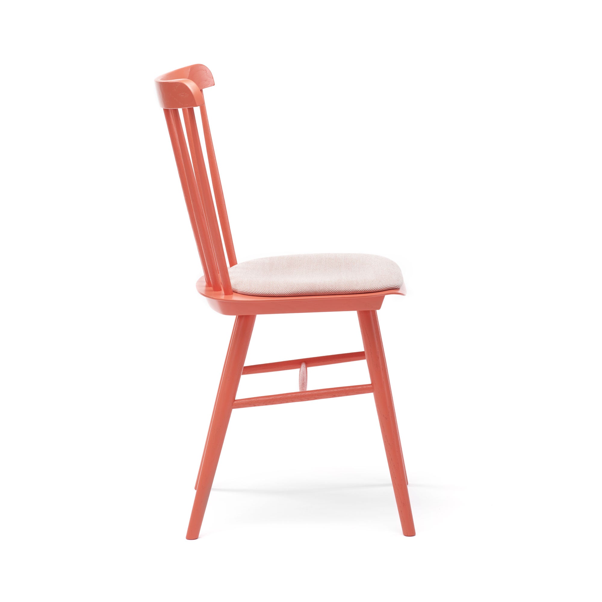 Side view of the TON Chair Ironica - Upholstered, featuring a modern wooden design with a light coral finish. It has a beige cushioned seat, retro style with vertical back slats, and slightly angled legs.