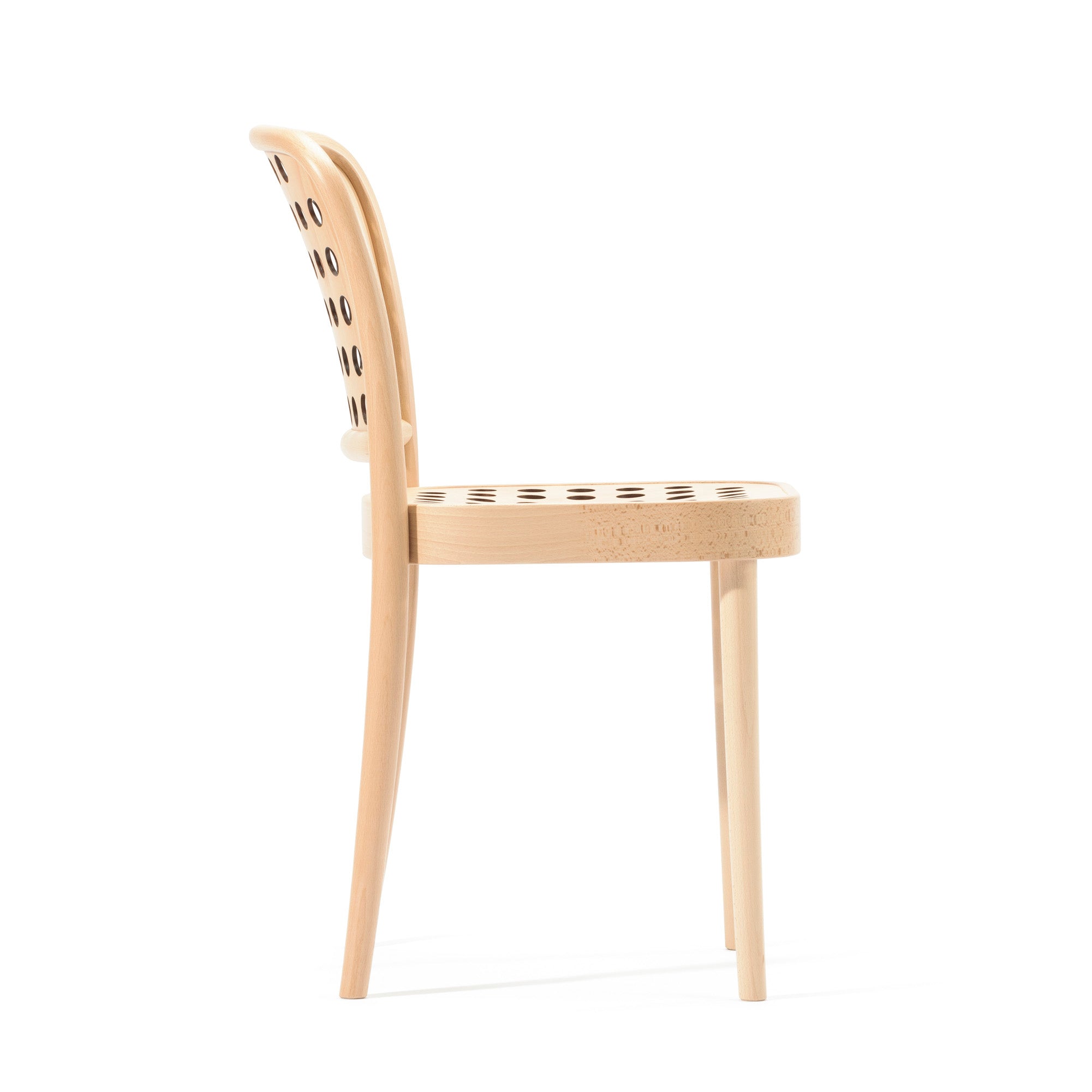 Side view of the Chair 822 by TON, a minimalist wooden chair with a curved backrest and seat featuring circular cutouts. Crafted using manual wood-bending technology, this Scandinavian design has four legs and a natural wood finish, embodying modern minimalism.