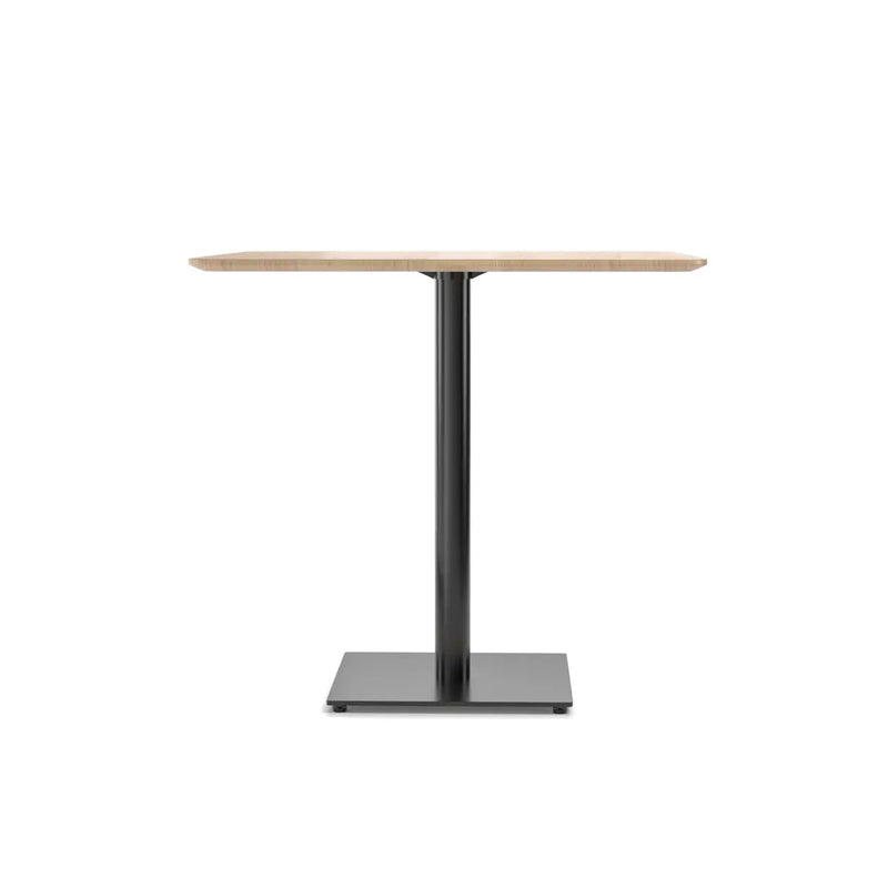 The TON Easy Bistro Table Rectangular features a modern, minimalist design with a light wood top and a sleek black metal pedestal base on a square foundation, ideal for mix and fix spaces.