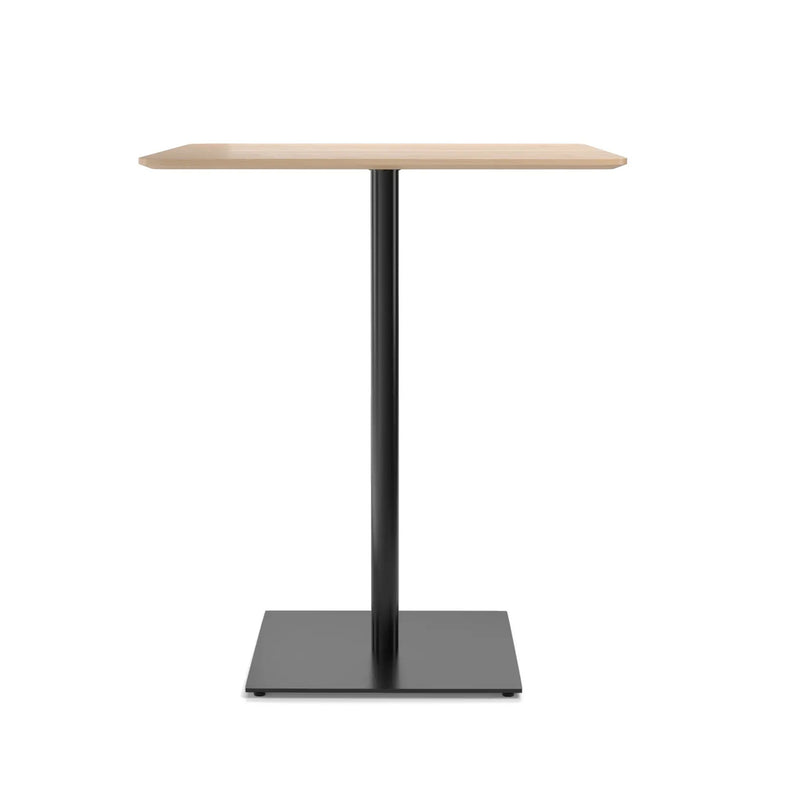 The Easy Bar Table Rectangular by TON is a minimalist pedestal table with a light wood top, sleek black metal leg, and sturdy steel base. Ideal for bistro and bar height settings, its design is simple and modern.