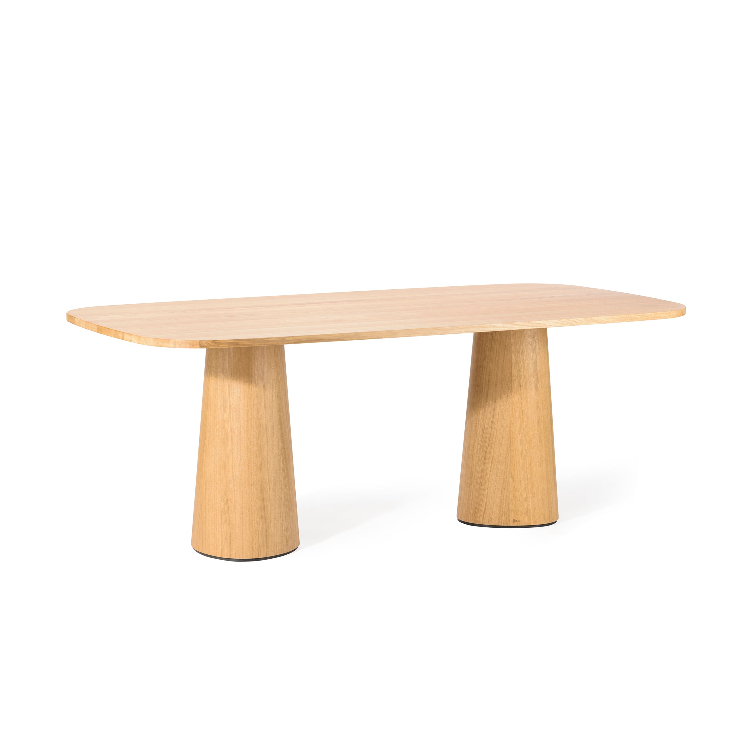 The P.O.V. Table 470 by TON is a rectangular wooden table with a smooth surface and rounded corners, supported by wide cylindrical legs. Crafted from solid wood with a light, natural finish, it complements any setting. The background is plain white.