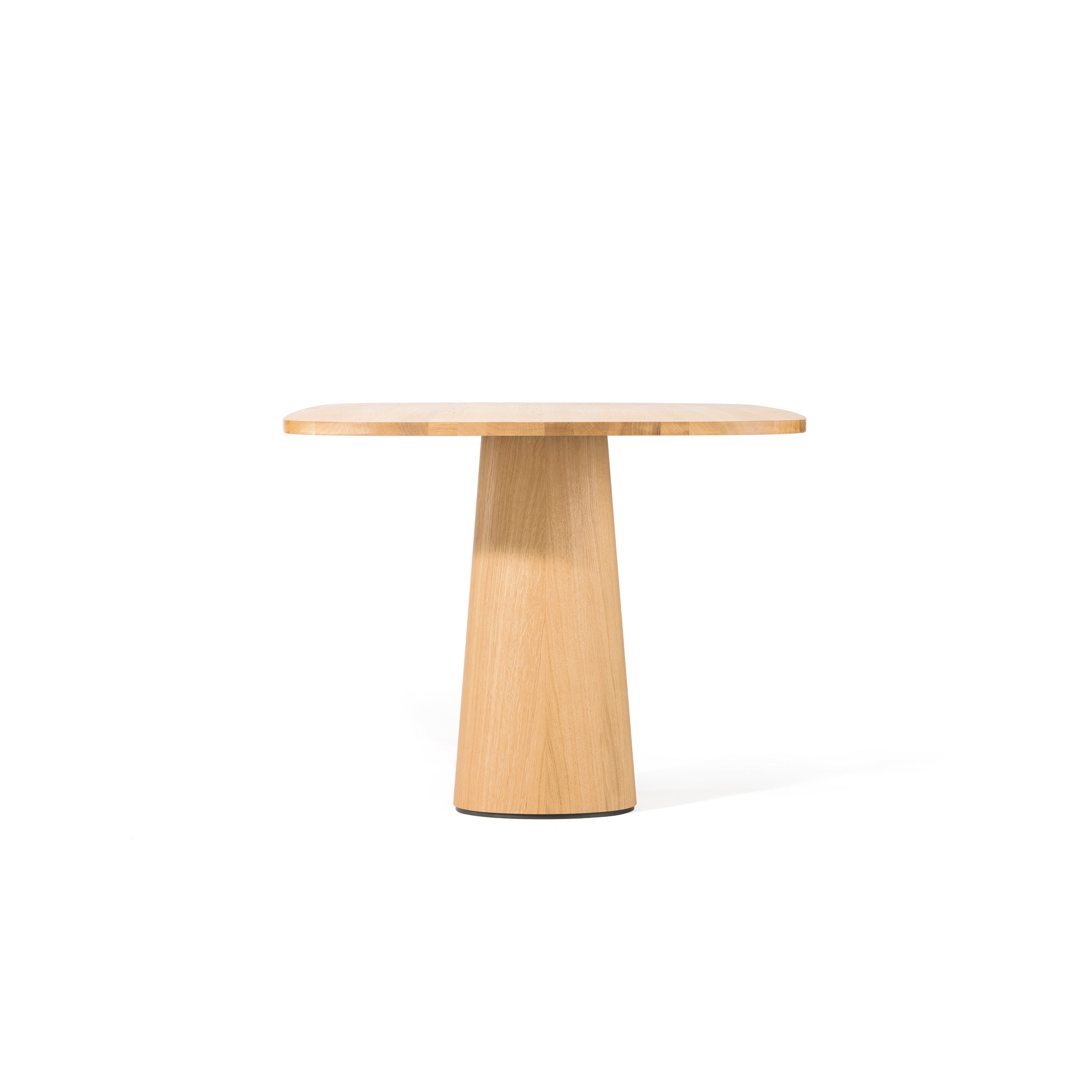 The TON P.O.V. Table 470, with its minimalist design and organic shape, showcases a solid wood round top and a thick, tapered central pedestal base, elegantly set against a plain white background.