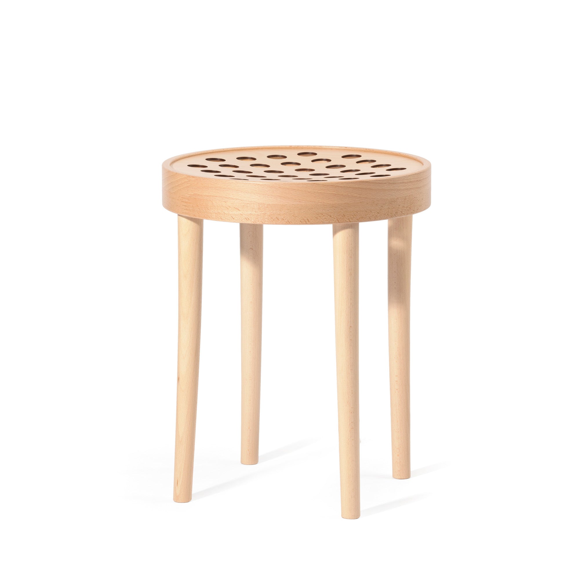 The Stool 822 by TON exemplifies Scandinavian minimalism with its round seat and circular cutouts. Supported by four straight, light-colored wooden legs, this piece echoes the minimalist style of Claesson Koivisto Rune.
