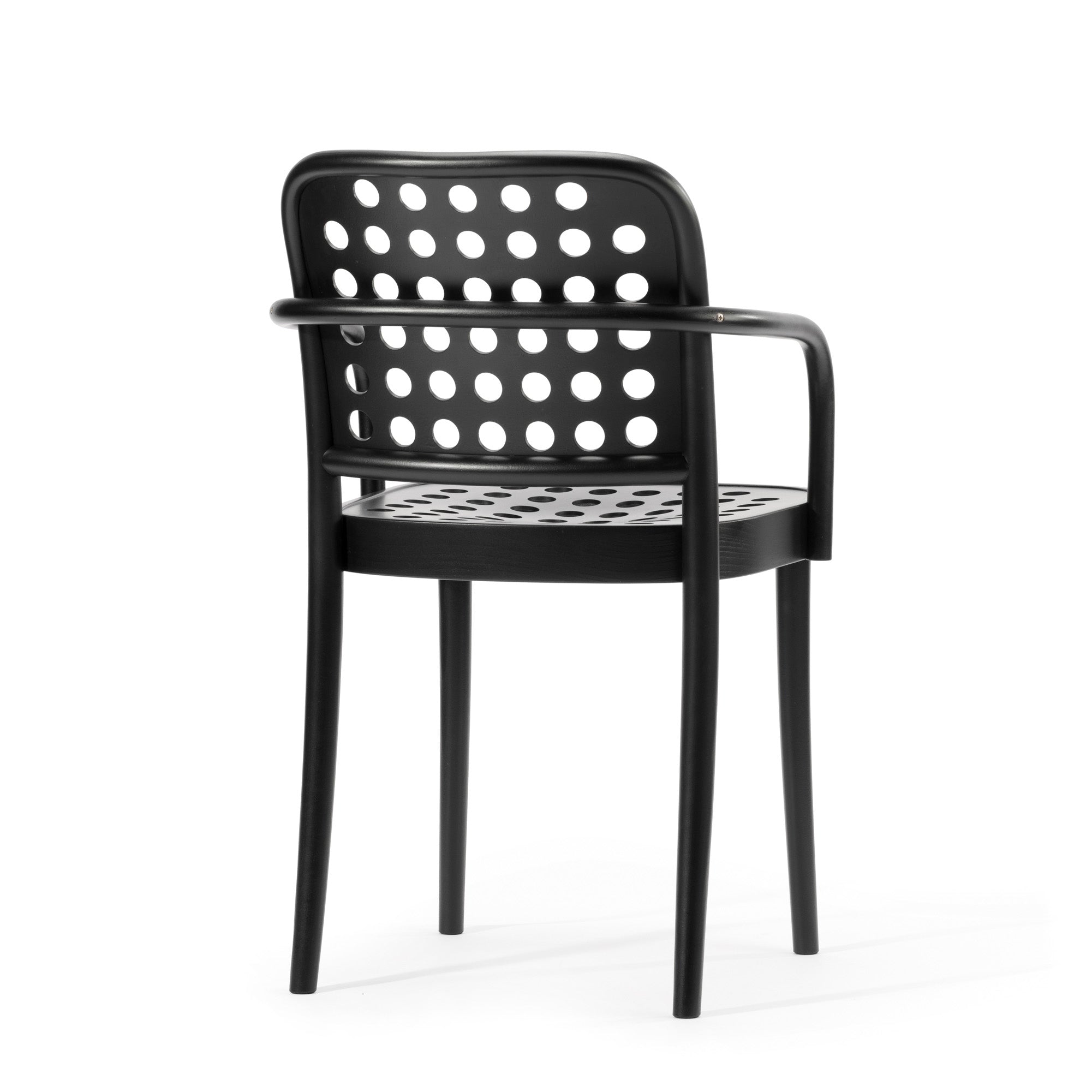 The Armchair 822 by TON is a black design featuring a rounded backrest and armrests with a perforated circular hole pattern. Inspired by Scandinavian minimalism, this piece from the TONDesigner seating collection showcases clean lines and a smooth finish for a modern, minimalist look.