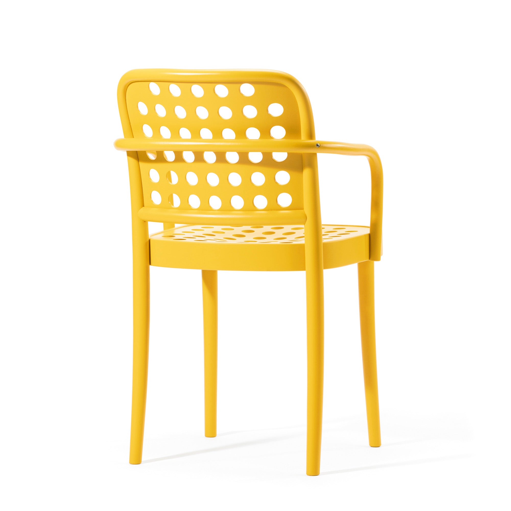 Experience modern elegance with the Armchair 822 from TON. Designed by Claesson Koivisto Rune, it features sleek Scandinavian minimalism, a bright yellow hue, perforated circular patterns, sturdy legs, and stylish armrests elegantly showcased from an angle.