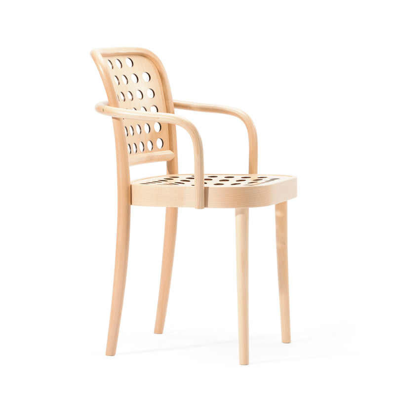 The Armchair 822 by TON features a Scandinavian minimalist design with light wood, curved backrest, and armrests. It has circular cut-out patterns on the seat and backrest, sleek legs, and perfectly fits in any contemporary seating collection by Claesson Koivisto Rune.