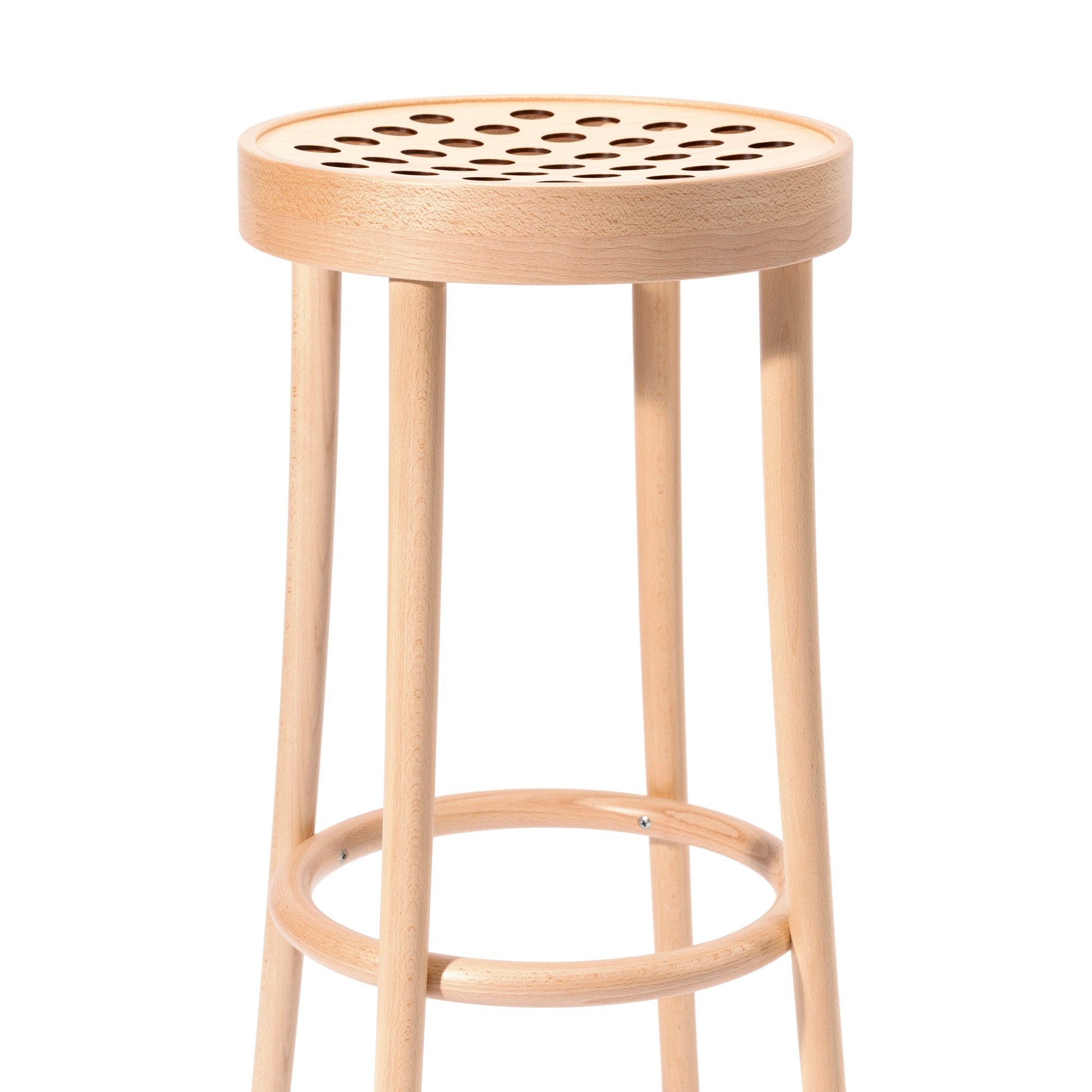 The Barstool 822 by TON features a round seat with circular cut-outs, epitomizing Scandinavian minimalism. Its four legs and circular support ring are crafted through manual wood-bending technology, showcasing a light, natural finish similar to Claesson Koivisto Runes designs.