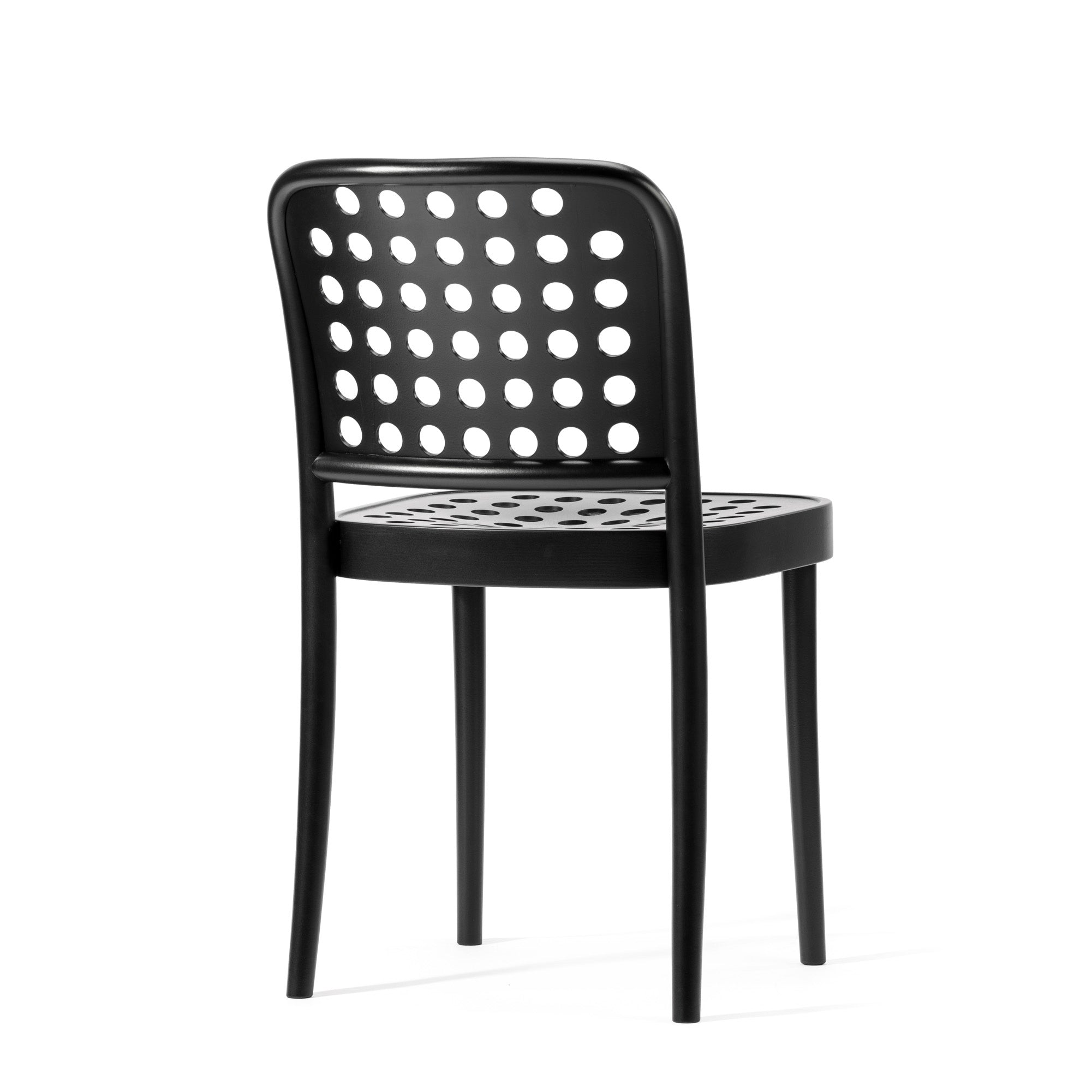The black Chair 822 by TON exemplifies Scandinavian minimalism with its perforated backrest and seat, showcasing evenly spaced circular holes. It stands on four simple legs, aligning with TONDesigners sleek aesthetic principles.
