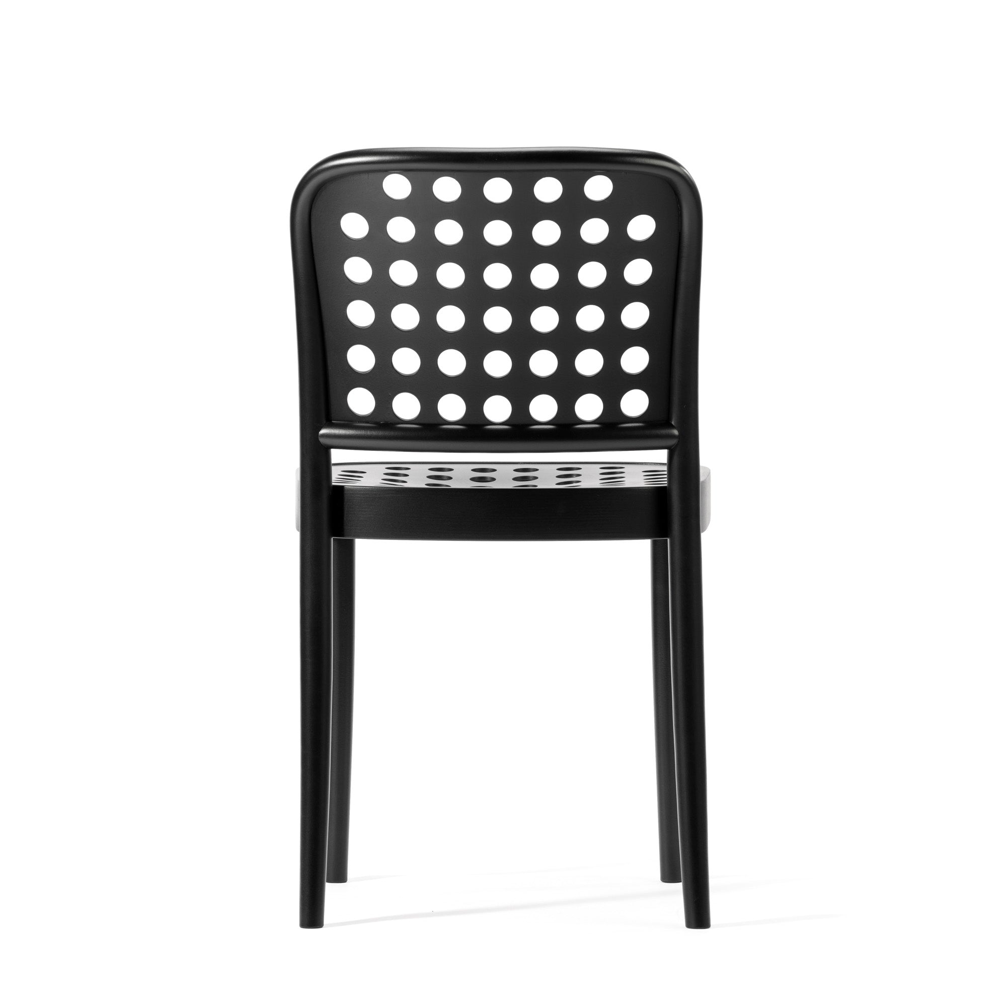 The Chair 822 by TON exemplifies Scandinavian minimalism with its black, perforated backrest featuring circular holes. Designed by TONDesigner, its a sleek and modern chair, perfectly balancing functionality and style against a pristine white background.