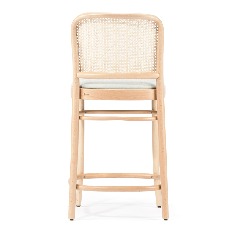 The Barstool 811 - Upholstered by TON is a minimalist beech wood stool with a natural finish, featuring a cane mesh backrest and light upholstered seat cushion, shown from the back.