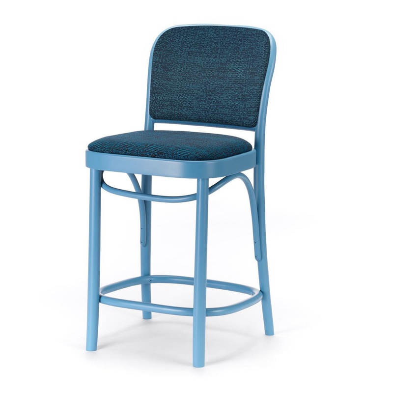 The TON Barstool 811 - Upholstered features a cushioned seat and backrest in textured dark fabric, accented by four beech wood curved legs with footrests. Simple modern design on a plain white background.
