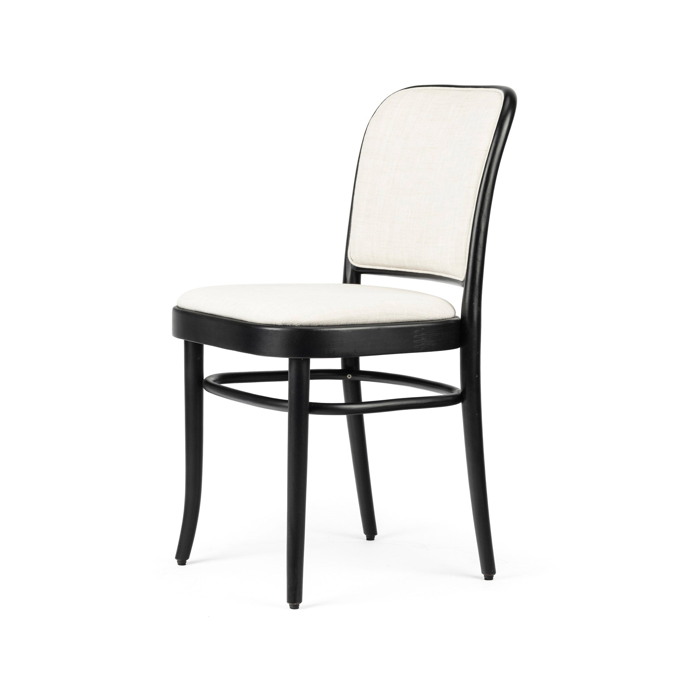 The Chair 811 by TON, now on sale, is a black wooden chair with light beige cushioned upholstery on the back and seat. Inspired by Josef Hoffmanns Art Nouveau style, it features rounded edges and slender legs for an elegant, modern look.