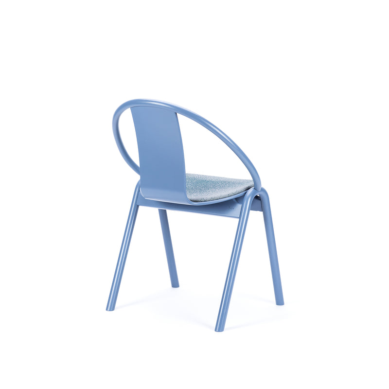 The Chair Again Upholstered by TON is a modern stackable dining chair with blue textured fabric seat, curved metal legs, and backrest. It’s minimalist yet elegant, perfect for saving space.