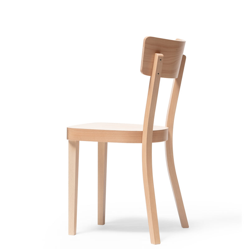 The Chair Ideal by TON features a simple design with a slightly curved backrest and upholstered seat. Made from light-colored beech, it stands on four straight legs, perfectly complementing a plain white background.