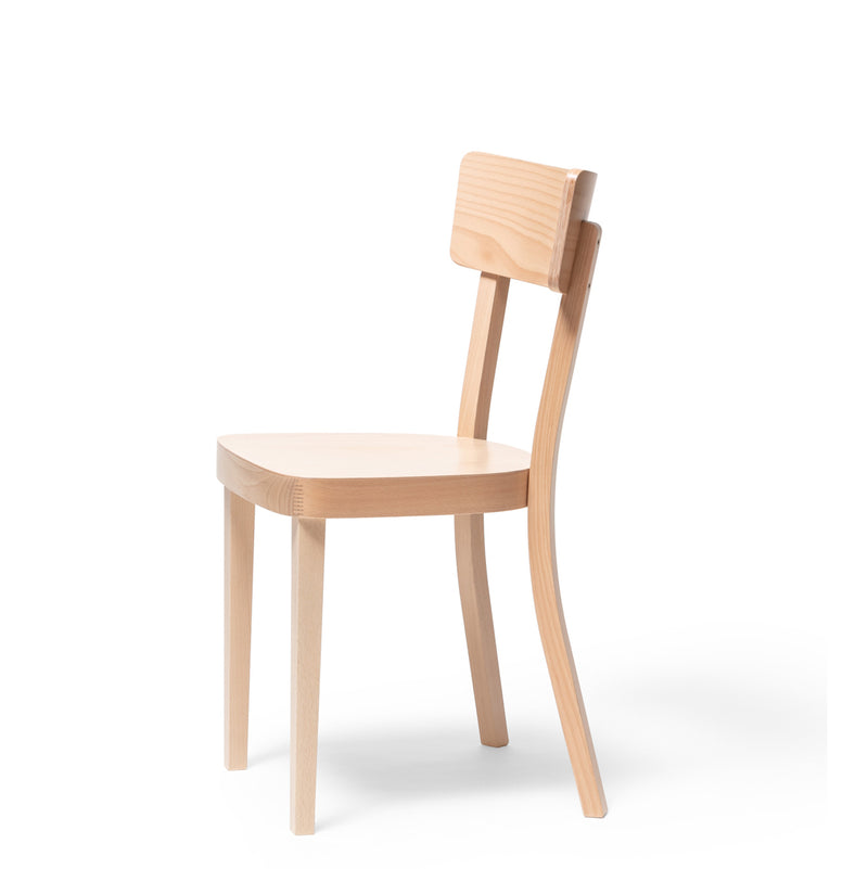 The Chair Ideal by TON is a minimalist wooden chair featuring a curved backrest, four legs, and a light-colored beech finish. Its modern design with an upholstered seat suits both dining and office spaces, elegantly displayed against a plain white background.