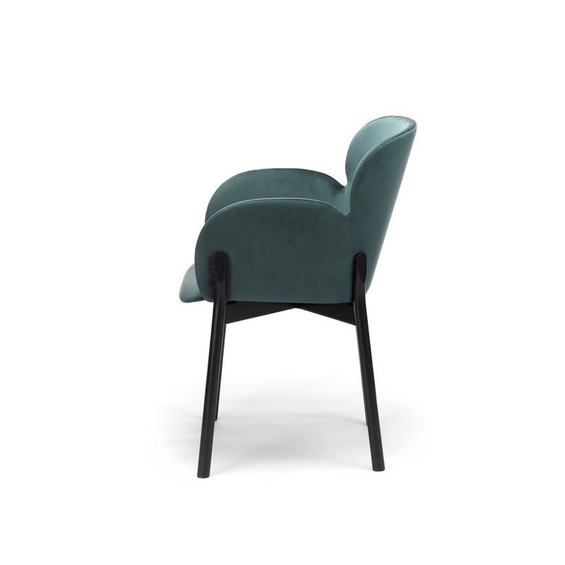 Side view of the Armchair Ginger by TON, featuring teal upholstery and black wooden legs. This chair highlights TONs wood-bending technique with its curved backrest and armrests, creating a sleek, contemporary design.