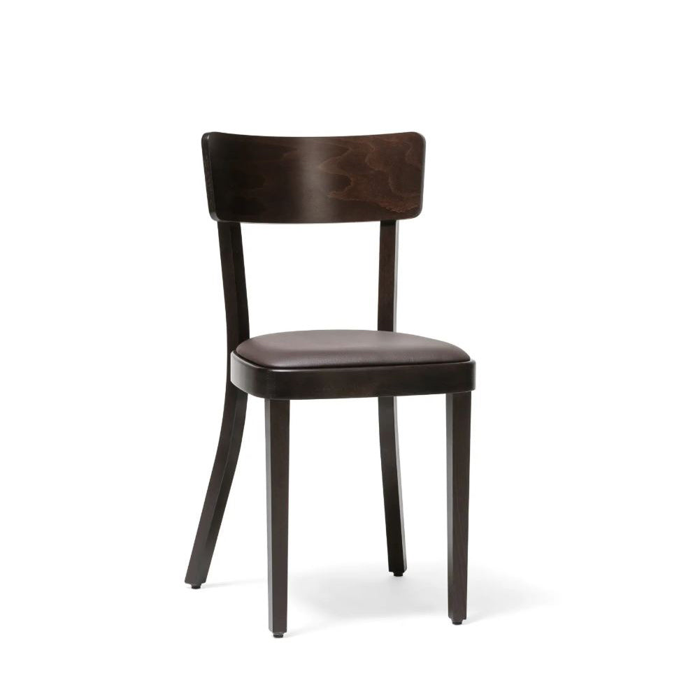 The Chair Ideal - Upholstered by TON is a dark wooden chair featuring a curved backrest and an armless, minimalist design. Its cushioned seat offers comfort, while straight legs add sleek appeal, making it perfect for dining rooms or the hospitality industry.