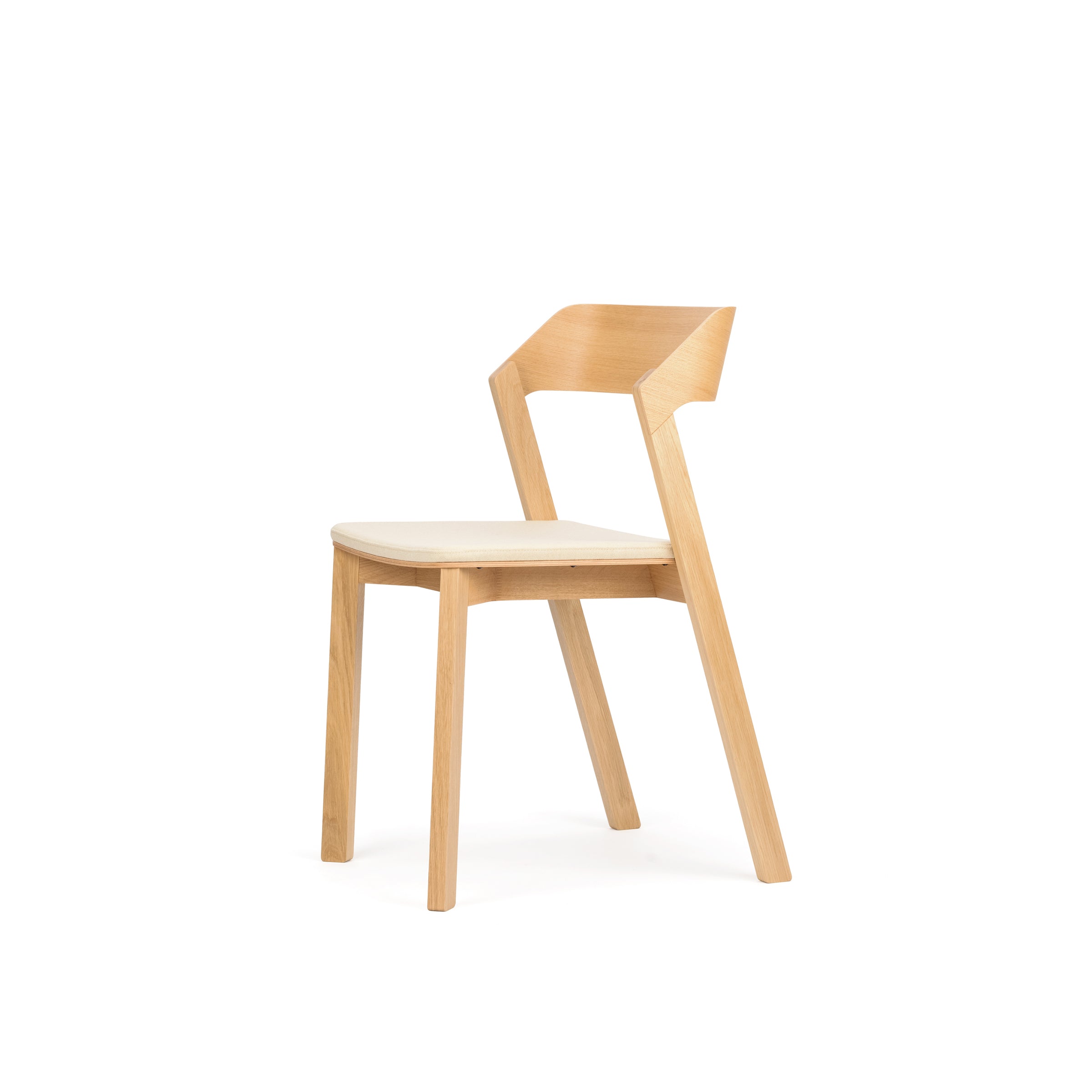 The Chair Merano - Upholstered by TON is a minimalist design in solid wood, boasting a light beige seat cushion and an angled backrest, with clean lines highlighted against a plain white background.