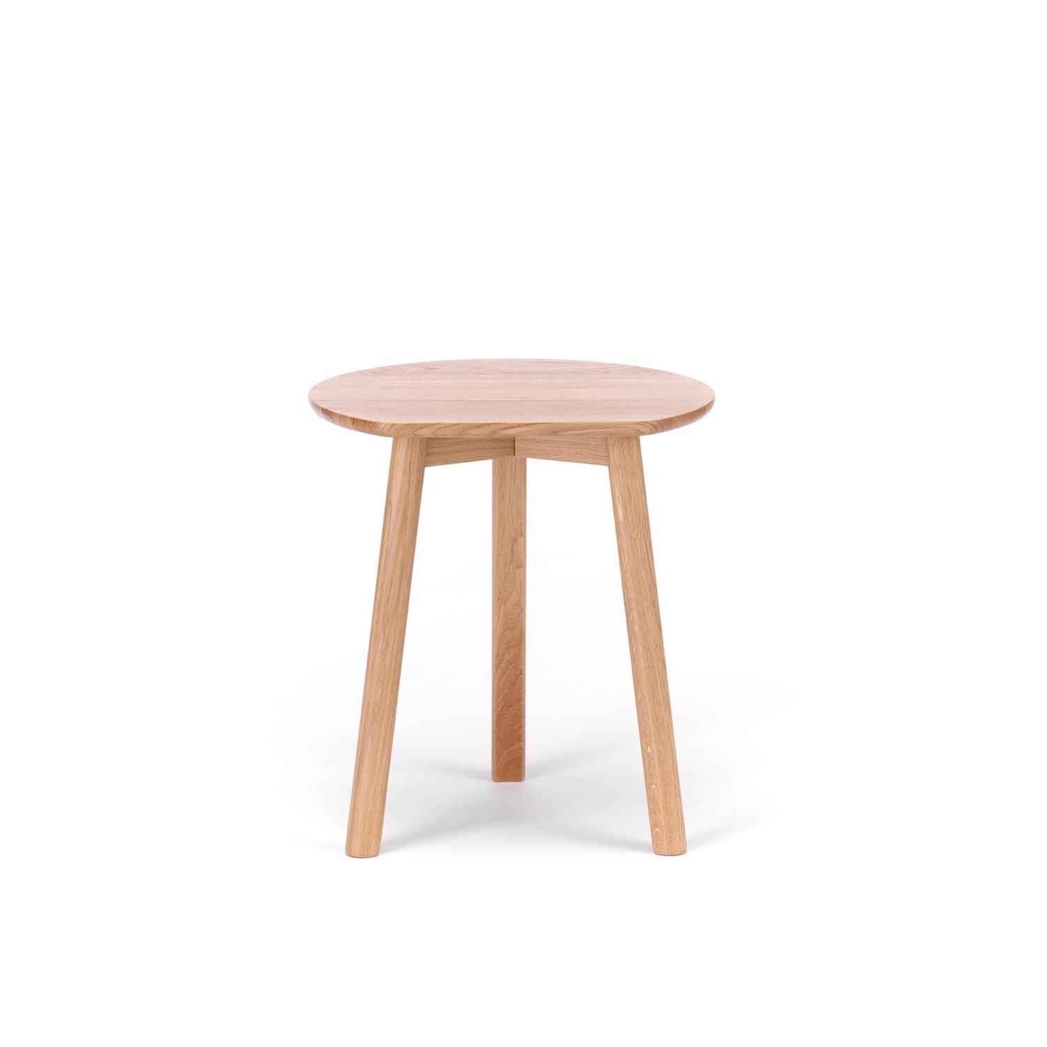 The YYY Coffee Table by TON, a compact round wooden piece made from natural oak with three sturdy legs, is set against a plain white background.