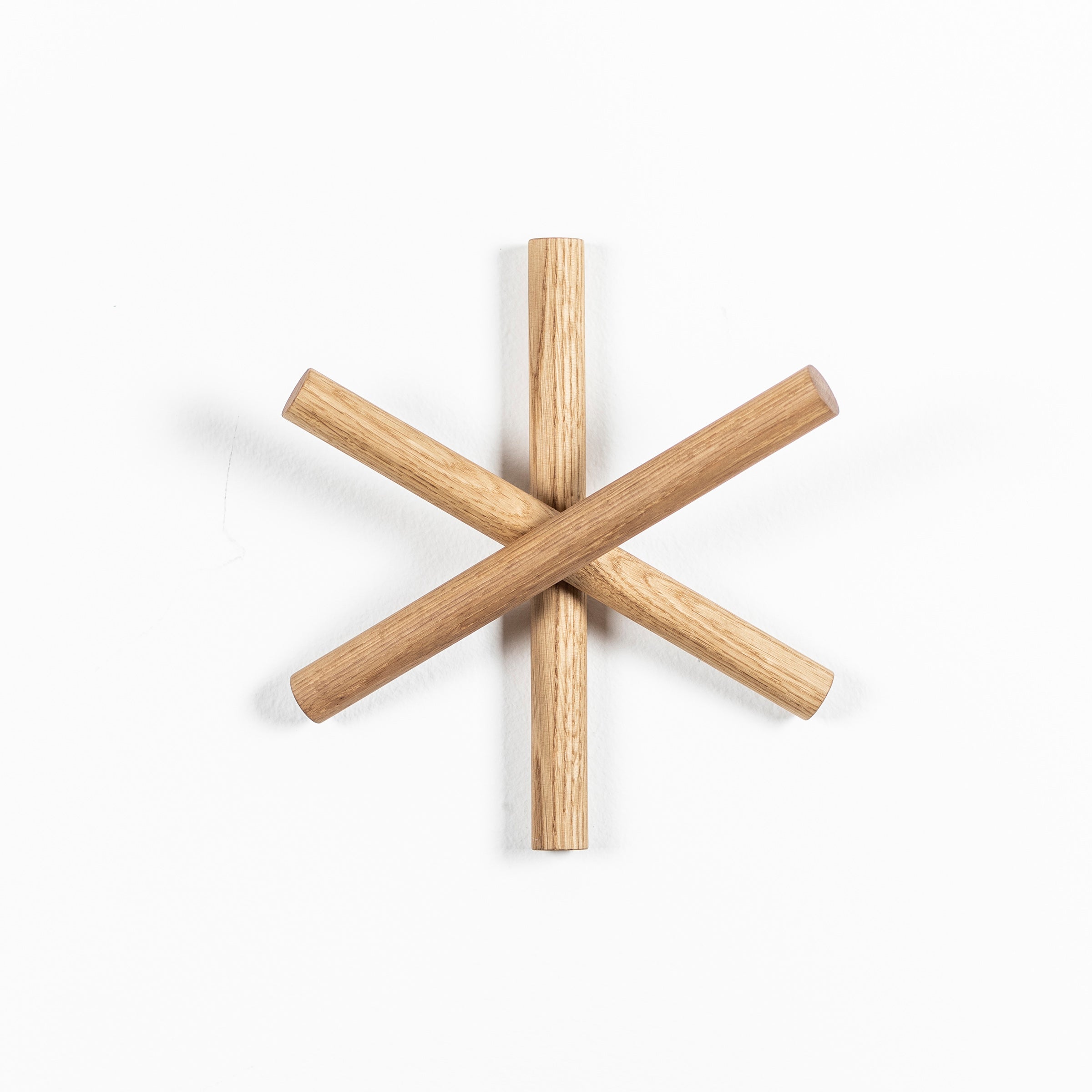 Crafted from quality wood offcuts, TONs Logs are elegantly arranged in an asterisk shape on a pristine white background.