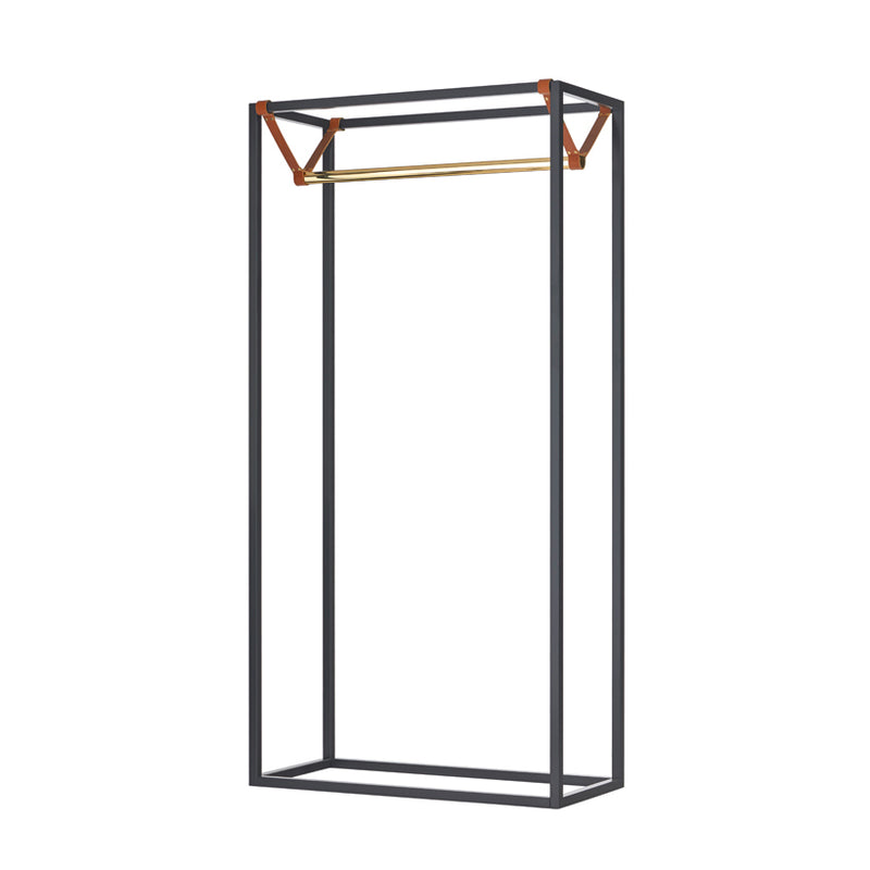 The LESS MESS Coat Stand by Victor Foxtrot boasts a minimalist open wardrobe design with a black, powder-coated steel frame and a polished brass hanging rod. Its rectangular structure is elegantly connected by two vegetable tanned leather straps, offering a modern touch.