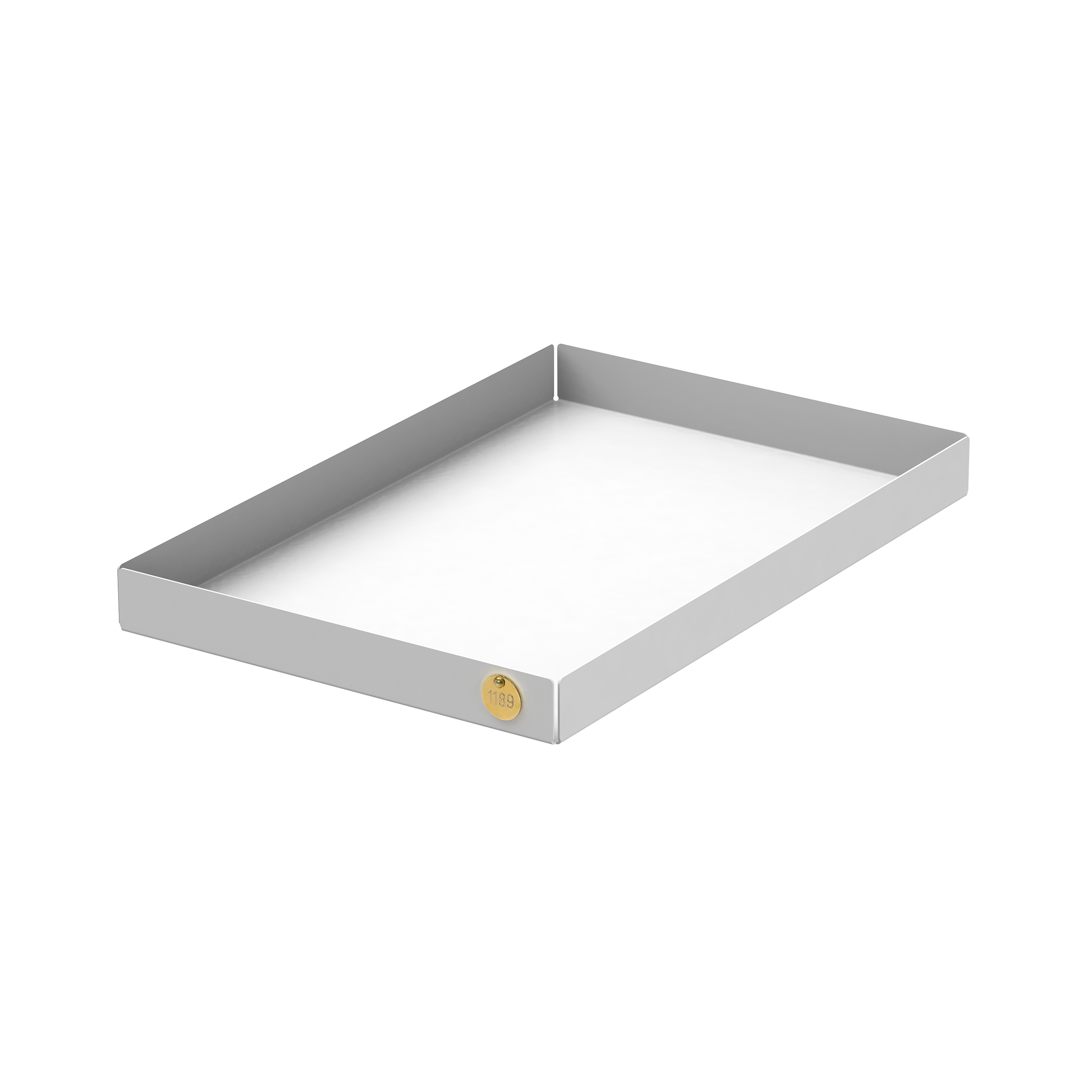 The POI Tray L by Victor Foxtrot is a rectangular, shallow tray made of powder-coated steel viewed slightly angled. A small round yellow sticker with a number decorates one corner, blending functionality with minimalist aesthetics against a plain white background.