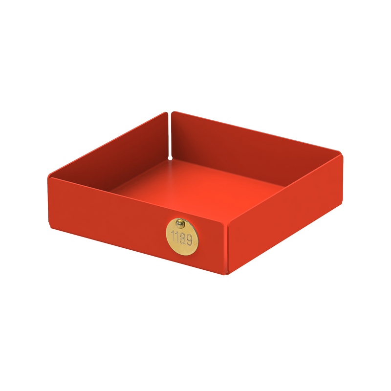 The POI Tray S by Victor Foxtrot is a red, open-top rectangular box with angled sides, designed for design lovers. Made from powder-coated steel, it sports a small circular gold label displaying the number 1189 on one side.